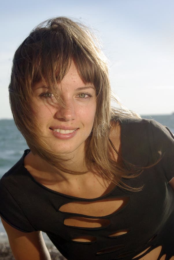 Happy young lady face on a beach