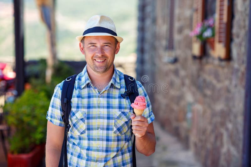 Happy young man holding ice cream