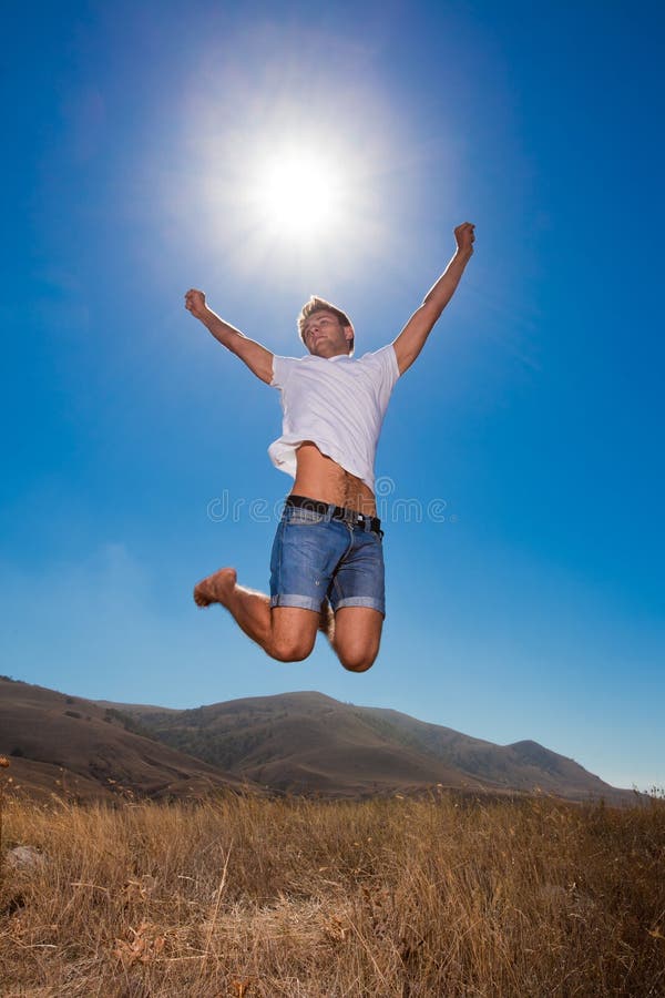 Happy young man jump in the mountains