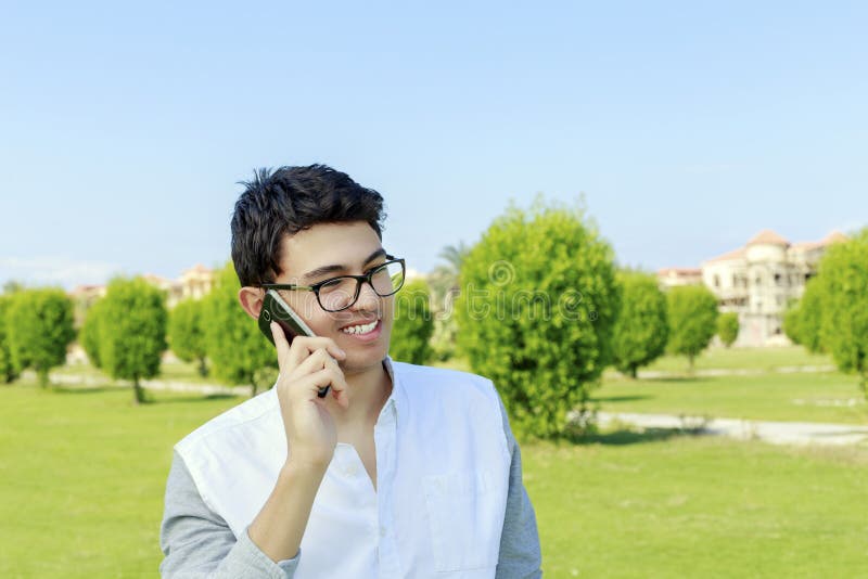 Happy young man on phone with great smile.