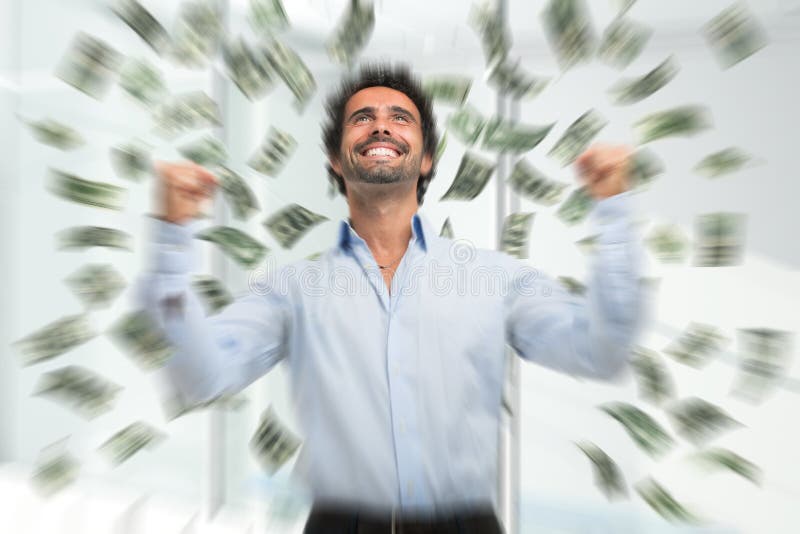 Happy young man in a rain of money royalty free stock images Happy young man in a rain of money royalty free stock images