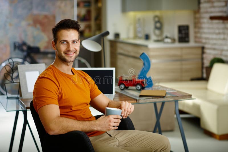 Happy young man at home stock images