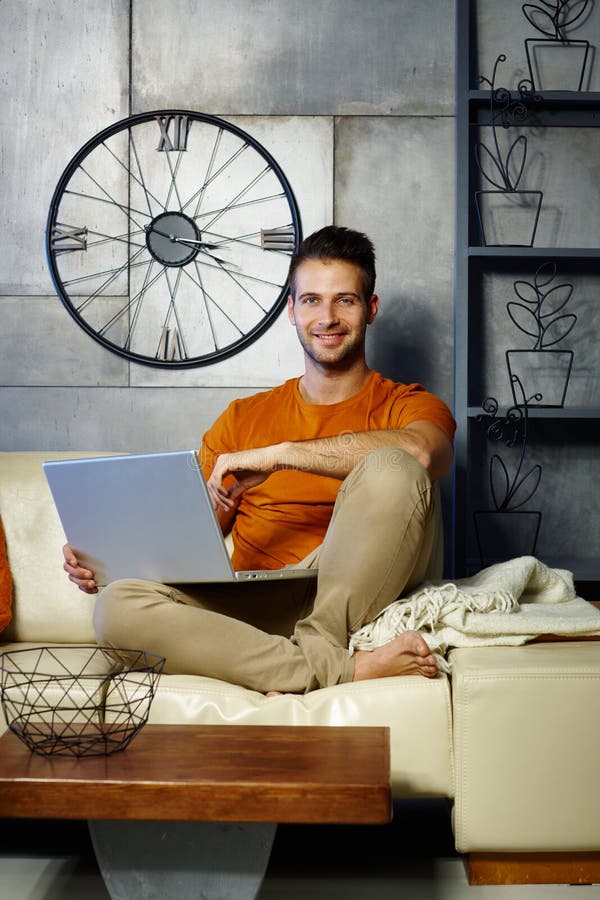 Happy man with laptop at home royalty free stock image