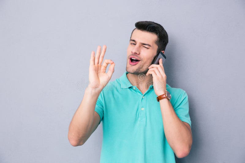 happy-young-man-talking-phone-gesturing-