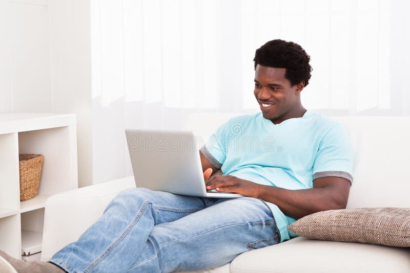 Happy young man using laptop royalty free stock images