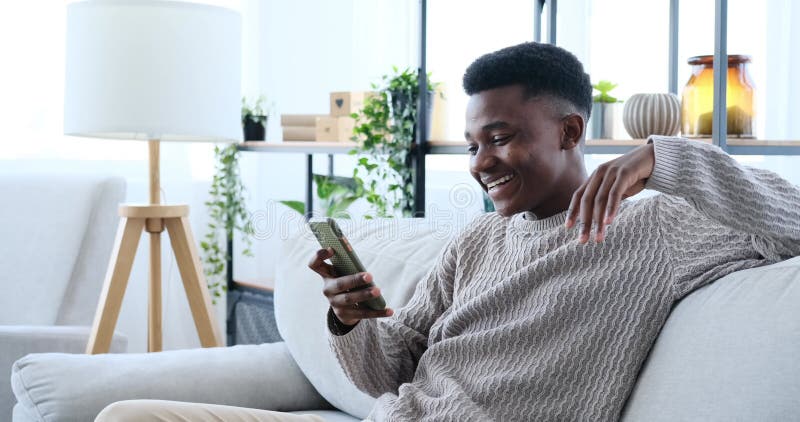 Happy young man video chatting using mobile phone stock footage