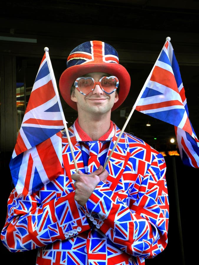 Happy young man waving United Kingdom flag stock photo Happy young man waving United Kingdom flag stock photo