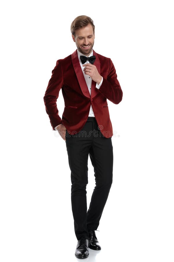 Happy young man wearing red velvet tuxedo and black bowtie royalty free stock photos Happy young man wearing red velvet tuxedo and black bowtie royalty free stock photos