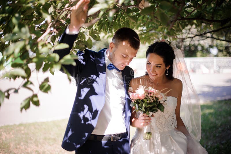 Happy and Young Married Couple Walking with a Bouquet of Flowers Stock ...