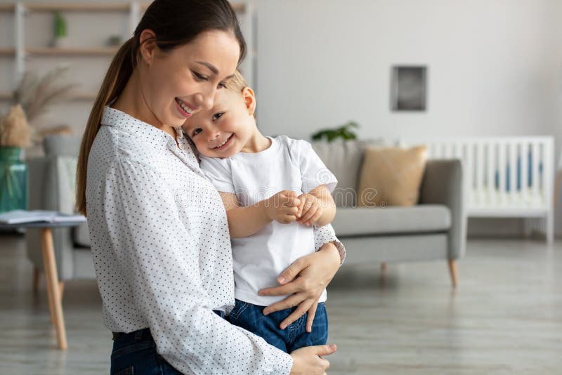 Happy Young Mom Embracing Leaning To Chest Toddler Son, Spending Time ...