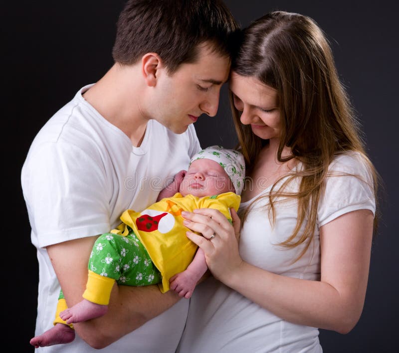 Happy young parents and newborn girl