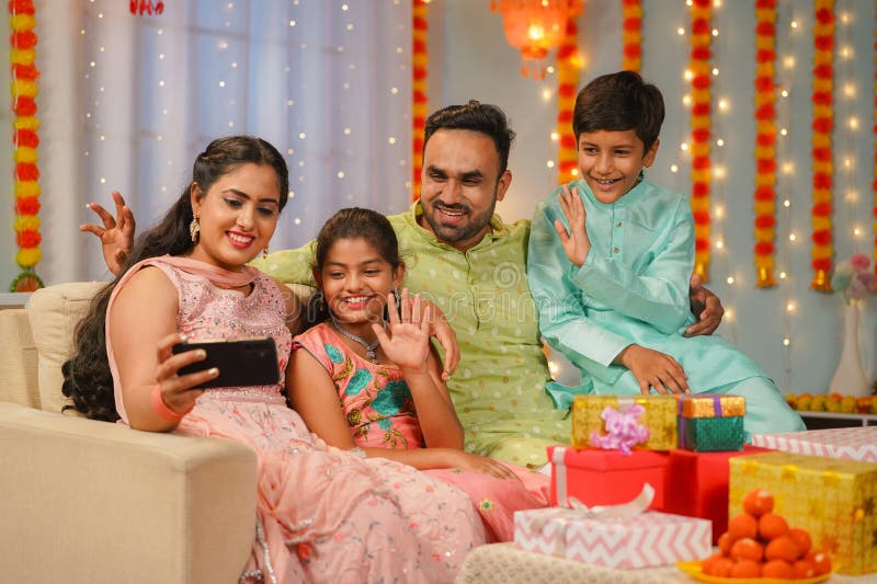 Image of Asian Indian Young Family Of Four Celebrating Diwali, Bhai Dooj Or  Raksha Bandhan-ZQ701785-Picxy