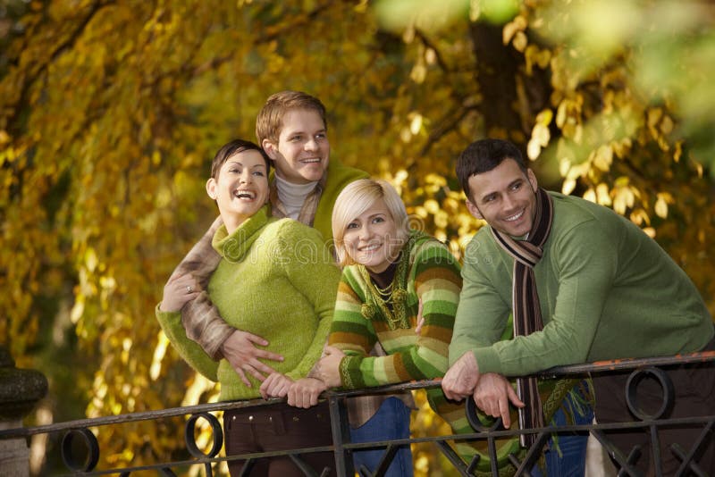 Happy young people in autumn park