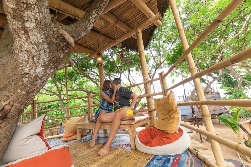 Happy Young Romantic caucasian Couple in gazebo on the tree, tropical Bali island, Indonesia.. Vacation Honeymoon