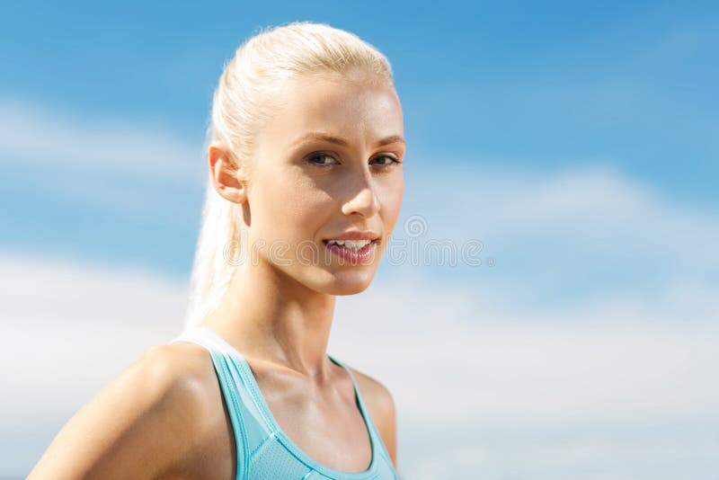 Happy young sporty woman outside