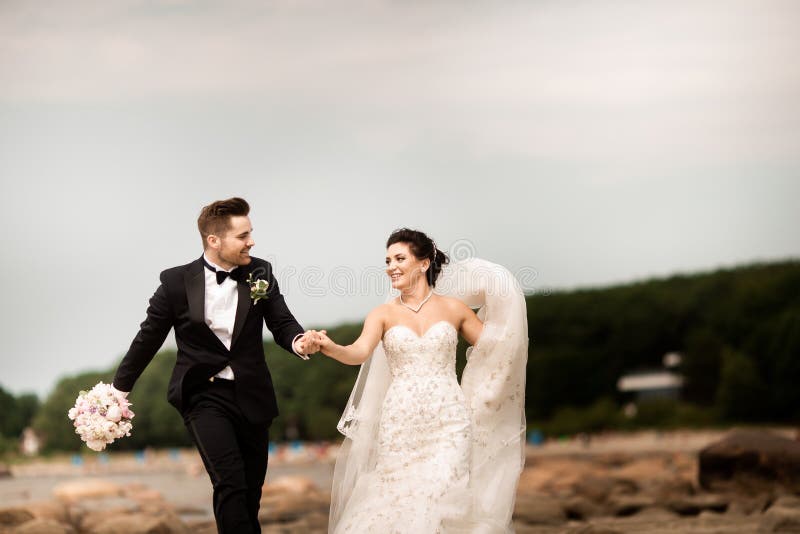 Happy young wedding couple having fun on the beach royalty free stock images Happy young wedding couple having fun on the beach royalty free stock images