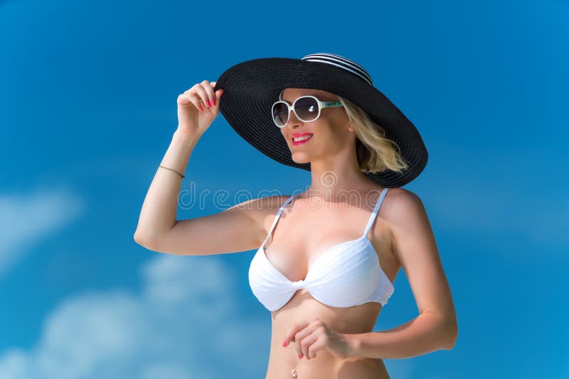 Happy young woman on the beach, beautiful female face outdoor portrait, pretty healthy girl relaxing outside, nature fun and joy