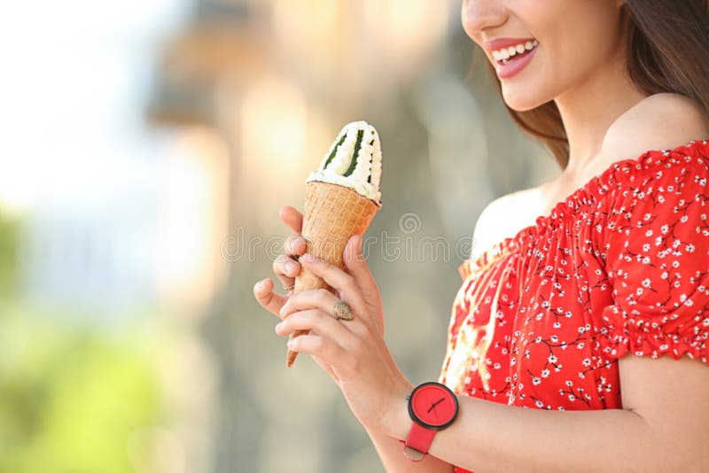 Happy young woman with delicious ice cream in waffle cone outdoors, closeup stock photos Happy young woman with delicious ice cream in waffle cone outdoors, closeup stock photos