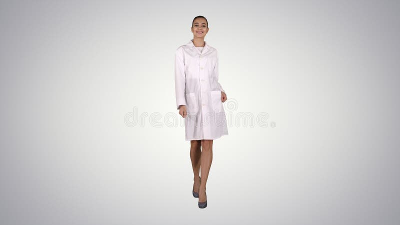 Happy young woman doctor dances on gradient background. royalty free stock photography Happy young woman doctor dances on gradient background. royalty free stock photography