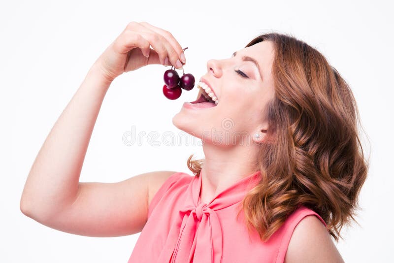 Happy young woman eating cherry stock photography Happy young woman eating cherry stock photography