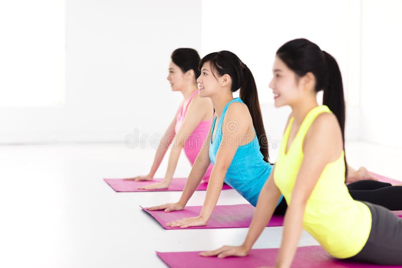 Happy young woman Group doing yoga exercises royalty free stock images Happy young woman Group doing yoga exercises royalty free stock images