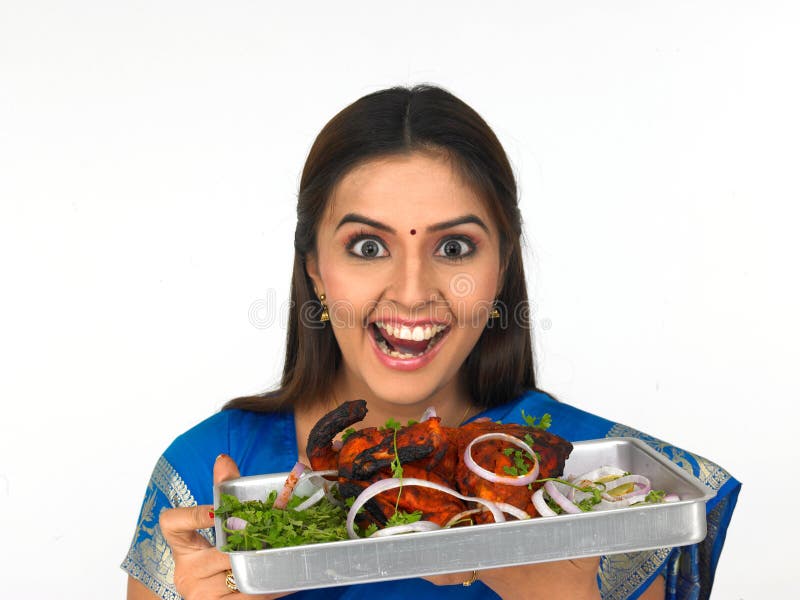 A happy young woman with her roasted chicken