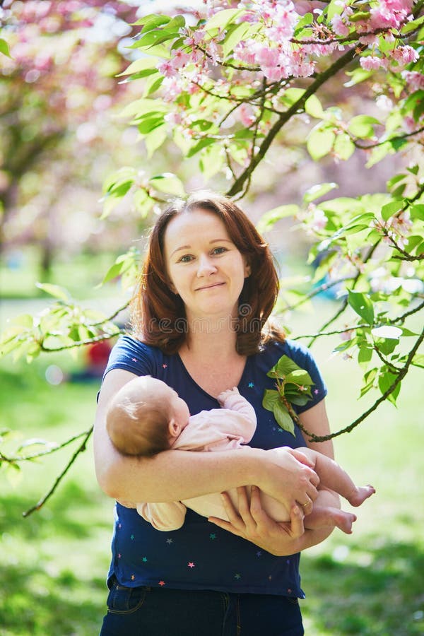 Happy young woman holding her little baby girl stock photos Happy young woman holding her little baby girl stock photos