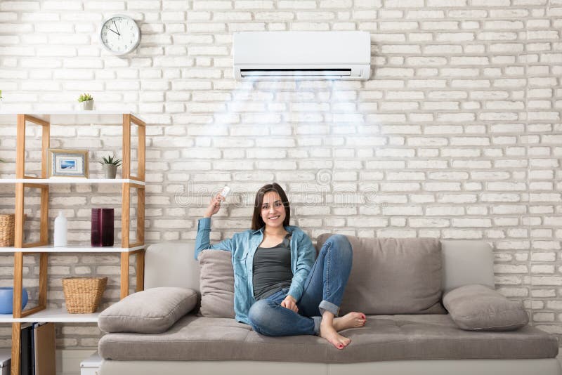 Woman Relaxing Under The Air Conditioner royalty free stock image Woman Relaxing Under The Air Conditioner royalty free stock image