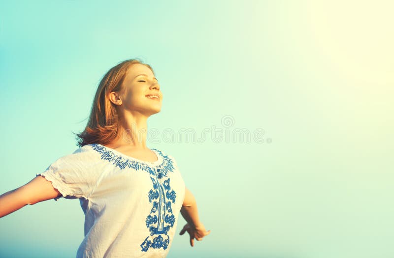 Happy young woman open her arms to the sky. And enjoying life Happy young woman open her arms to the sky. And enjoying life