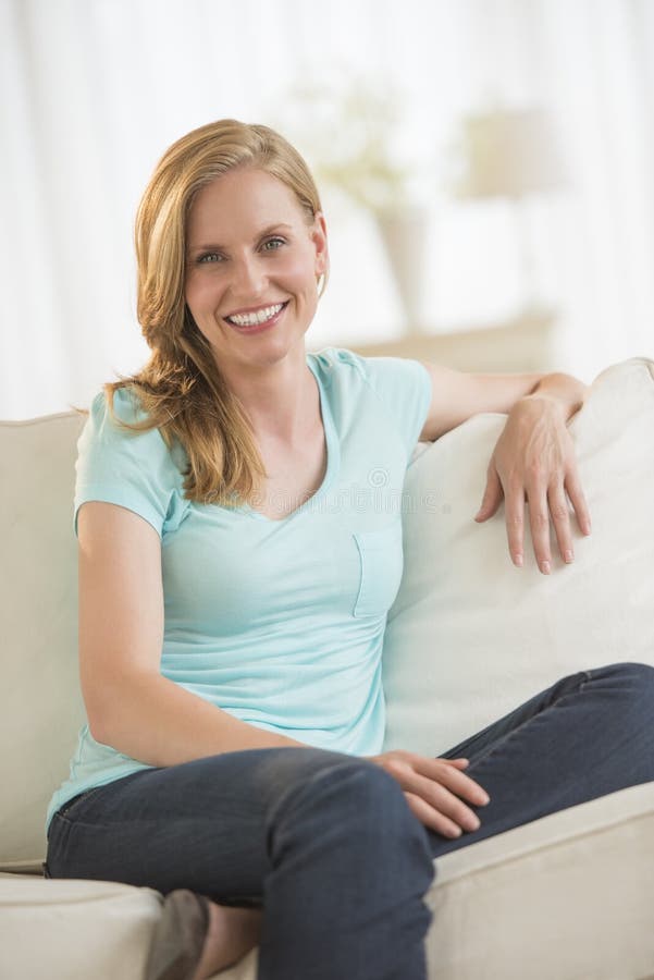 Happy Young Woman Relaxing On Sofa stock photos Happy Young Woman Relaxing On Sofa stock photos