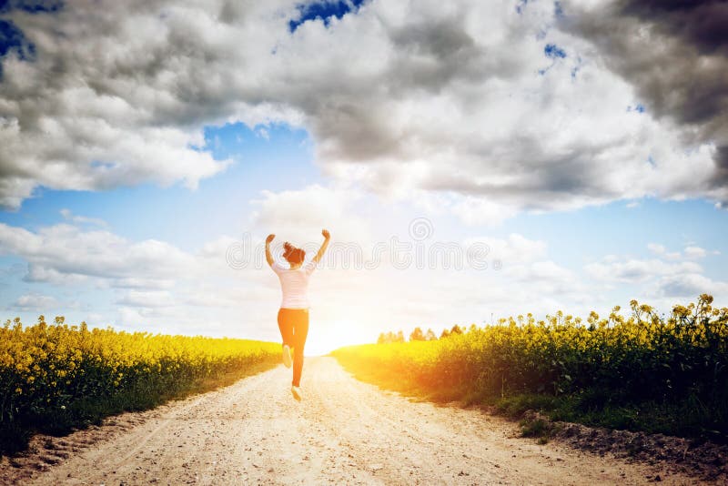 Happy young woman running and jumping for joy
