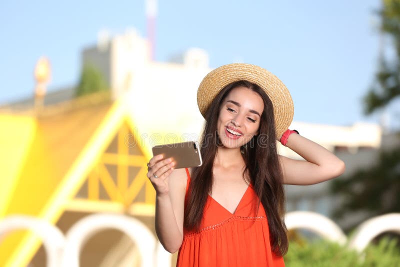 Happy young woman taking selfie outdoors on sunny stock photography Happy young woman taking selfie outdoors on sunny stock photography