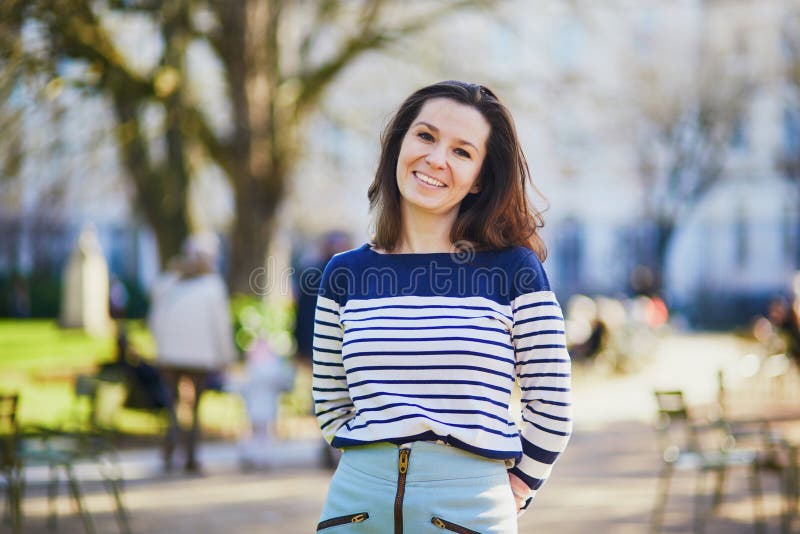 Happy young woman walking in the Luxembourg garden of Paris royalty free stock image Happy young woman walking in the Luxembourg garden of Paris royalty free stock image