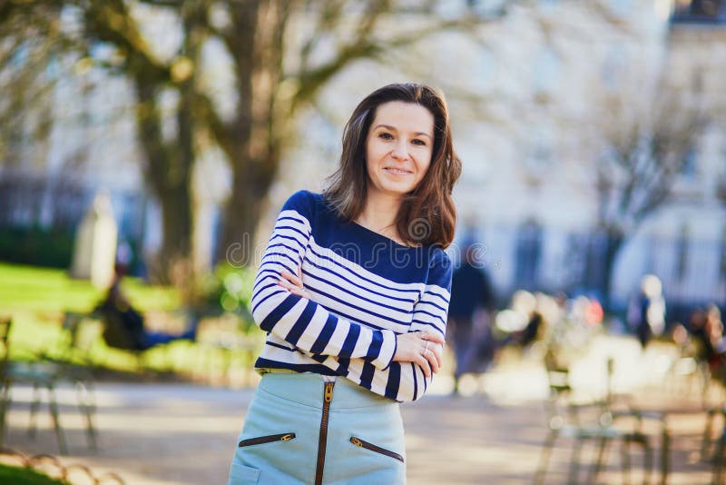 Happy young woman walking in the Luxembourg garden of Paris royalty free stock photo Happy young woman walking in the Luxembourg garden of Paris royalty free stock photo