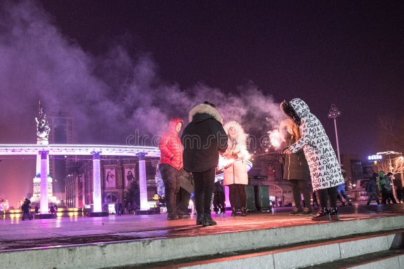 Harbin Ice Festival, people in stalin park having fun with sparklers, no faces at night