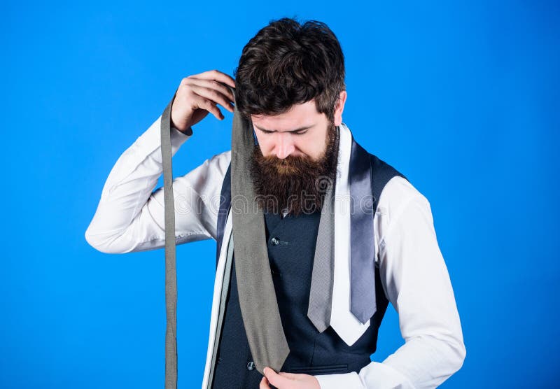 Hard choice to make. Bearded man choosing tie from luxury collection, choice concept. Salesman offering a good choice of design neckties. Brutal hipster making a choice.