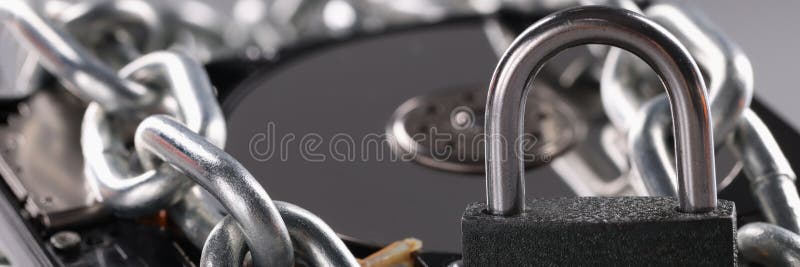 Hard Drive is Wrapped in Chain and Secured with Padlock Stock Photo