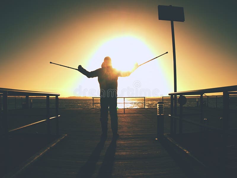 Hard walk of hurt man with crutches on port pier stock photography Hard walk of hurt man with crutches on port pier stock photography