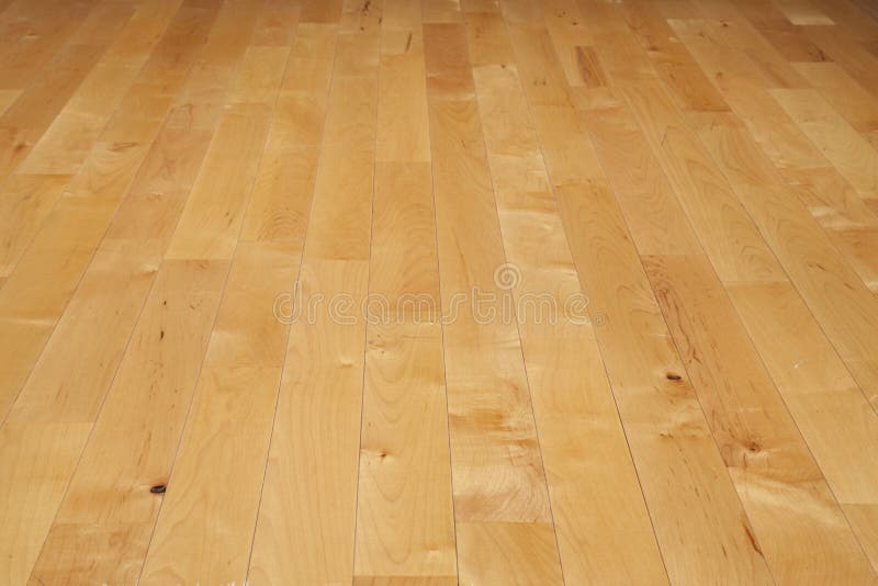 Hardwood basketball court floor viewed from a low angle