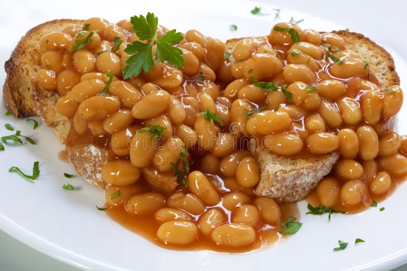 Baked beans on sourdough toast, garnished with parsley. Baked beans on sourdough toast, garnished with parsley.