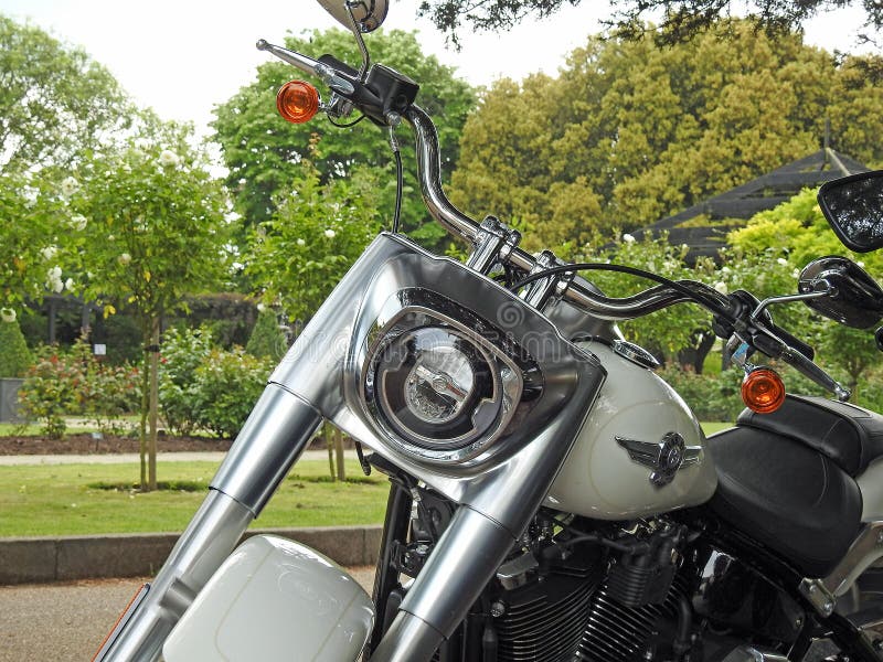 Photo of an american harley davidson superbike motorcycle with twin exhaust pipes and 114 cubic inch v-twin engine showing detail to front forks and headlamp. Photo of an american harley davidson superbike motorcycle with twin exhaust pipes and 114 cubic inch v-twin engine showing detail to front forks and headlamp.