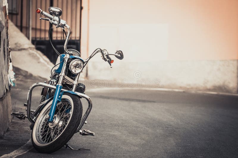 Harley Davidson-style motorcycle parked at the side of the road. Harley Davidson-style motorcycle parked at the side of the road