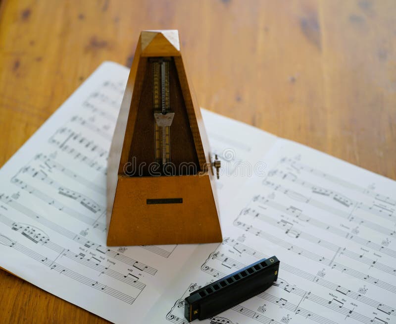 Harmonica and a Metronome Practice Time. Stock Image Image of