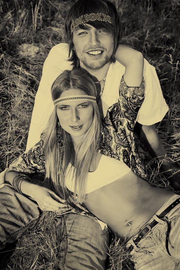 Beautiful young couple hippie posing together over picturesque landscape.