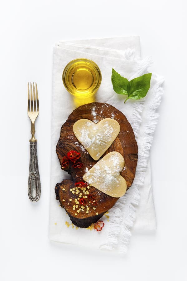 Heart shaped food. delicious ravioli. freshly homemade. on a board made of olive wood. Heart shaped food. delicious ravioli. freshly homemade. on a board made of olive wood