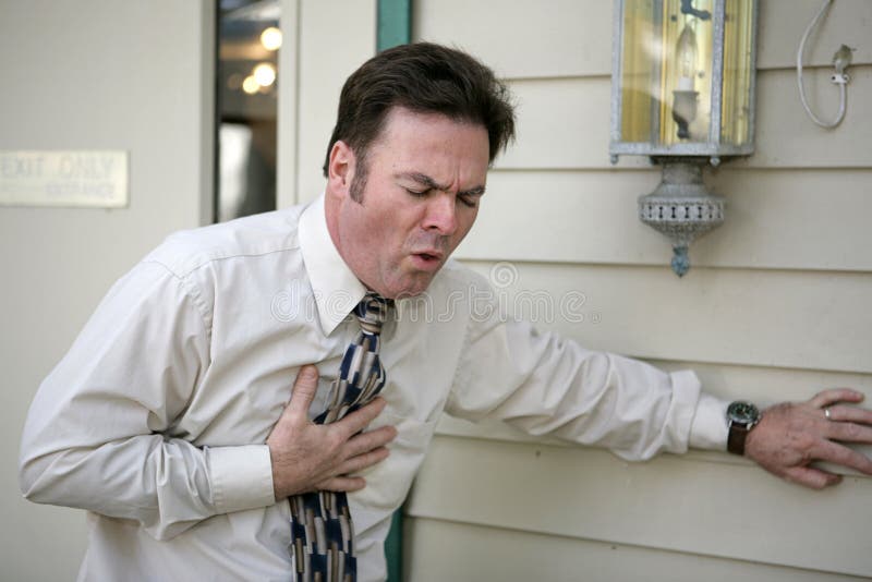 A middle aged man outside his office suffering from a persistent cough. A middle aged man outside his office suffering from a persistent cough.