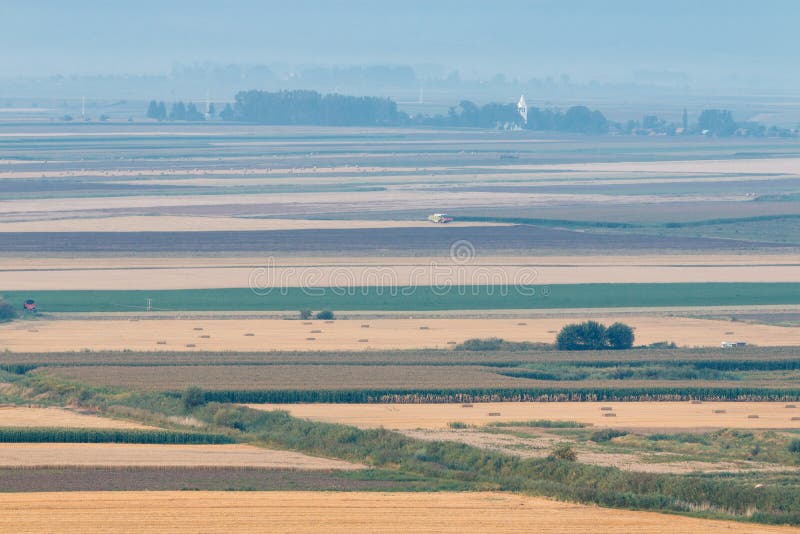 Harvester doing agricultural seasonal work in the field. Harvester doing agricultural seasonal work in the field, from above, drone picture stock image Harvester doing agricultural seasonal work in the field. Harvester doing agricultural seasonal work in the field, from above, drone picture stock image