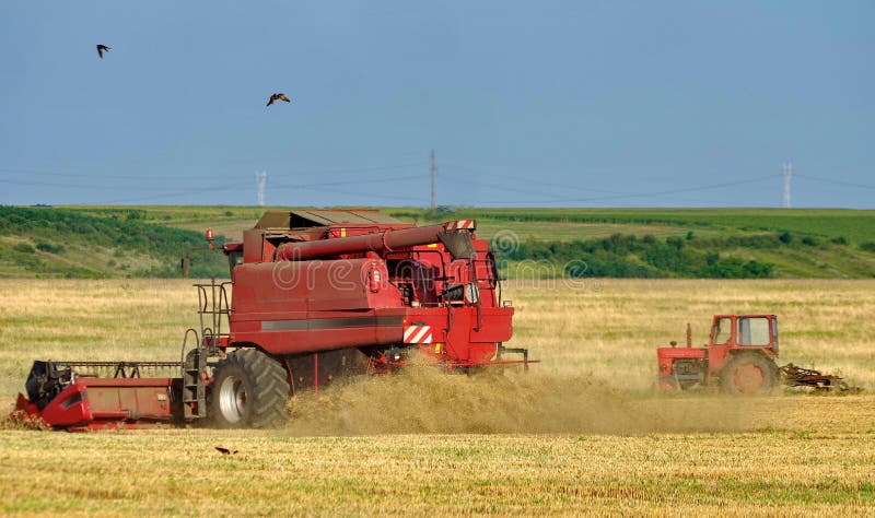Autumn landscape. Harvester and tractor on the field stock photo Autumn landscape. Harvester and tractor on the field stock photo