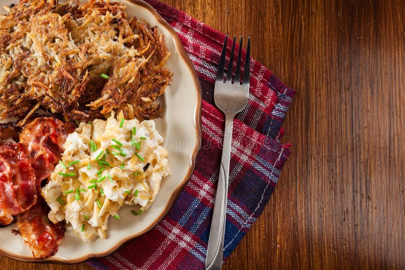 Hash Browns. Potato Pancakes with Crispy Fried Bacon and Scrambl Stock