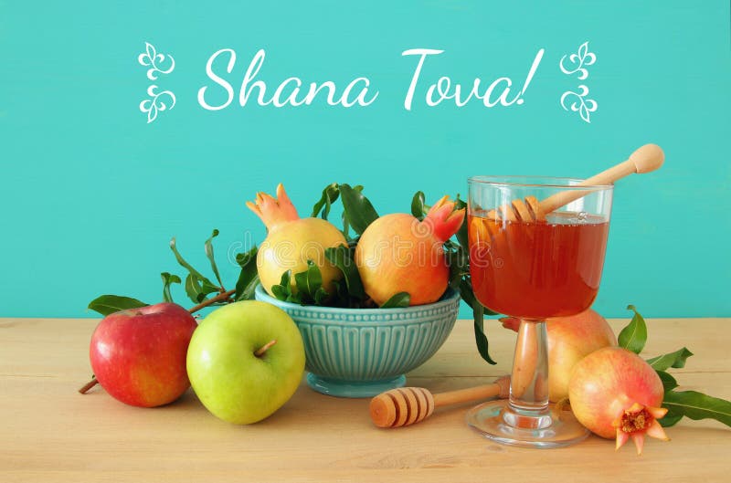 Rosh hashanah & x28;jewish New Year holiday& x29; concept. Traditional symbols. Text SHANA TOVA means HAPPY NEW YEAR in hebrew. Rosh hashanah & x28;jewish New Year holiday& x29; concept. Traditional symbols. Text SHANA TOVA means HAPPY NEW YEAR in hebrew